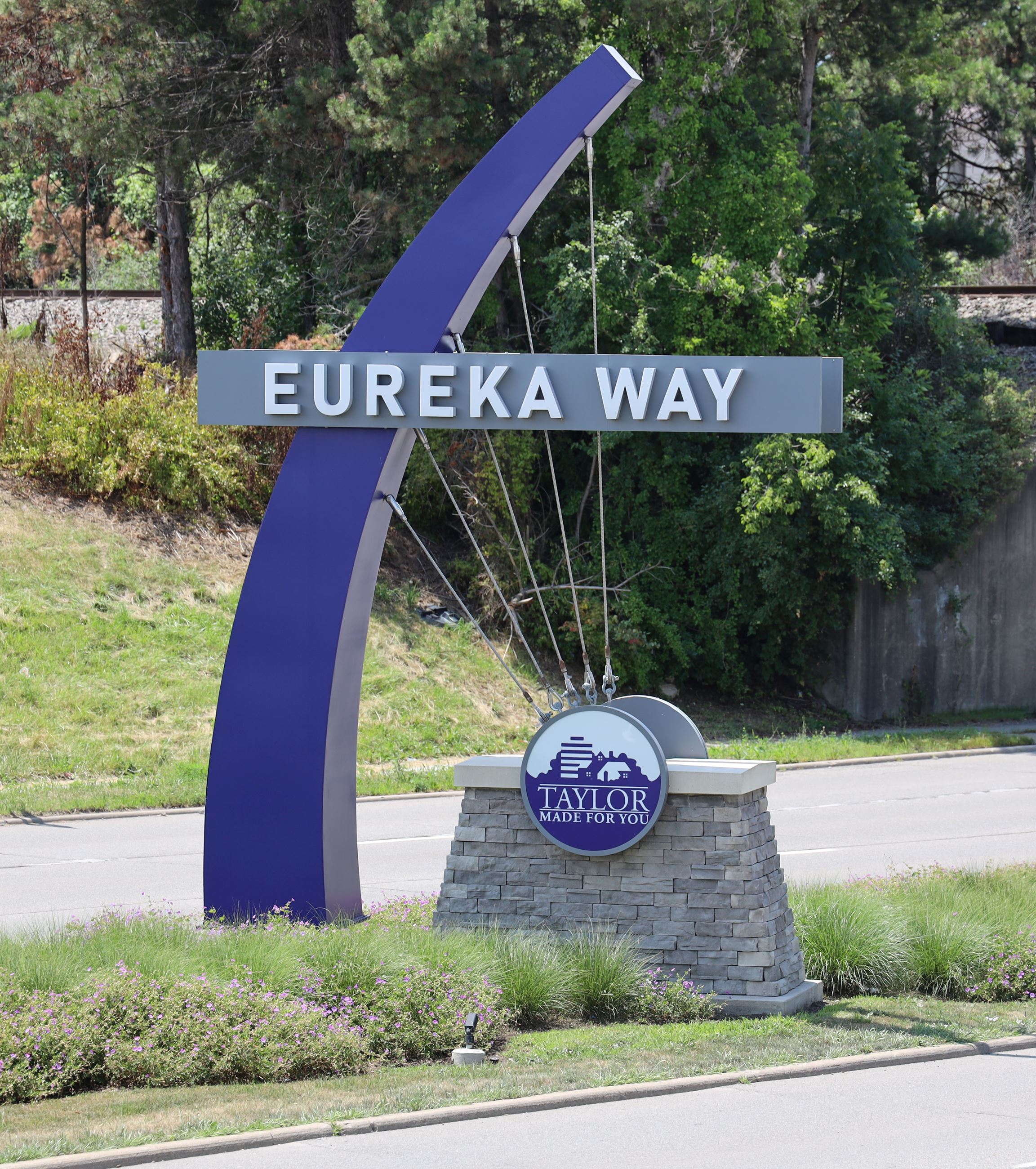 Image of the decorative landscaping named "Eureka Way." A blue half arch coming out of the gro