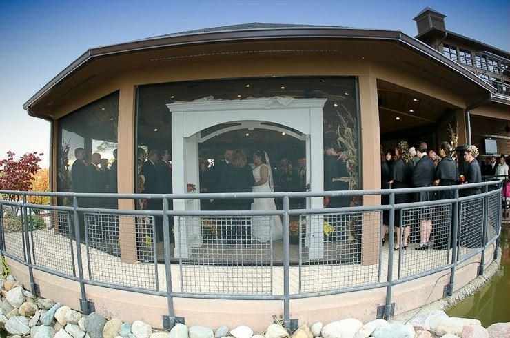 A bride and groom getting married in the banquet center.
